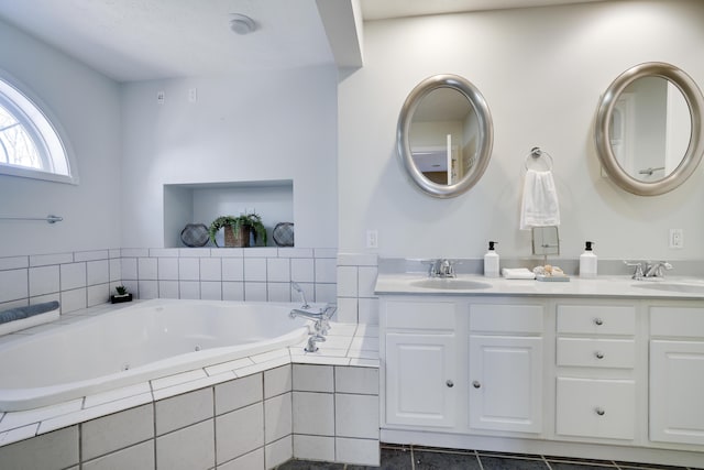 full bath featuring double vanity, a whirlpool tub, and a sink