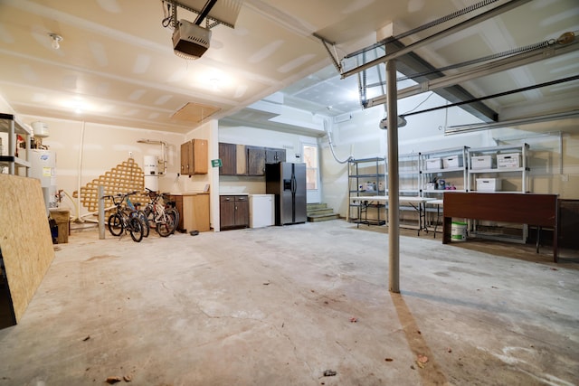 garage with electric water heater, a garage door opener, and stainless steel fridge with ice dispenser