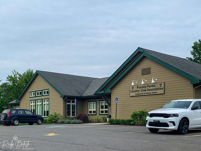 view of building exterior with uncovered parking