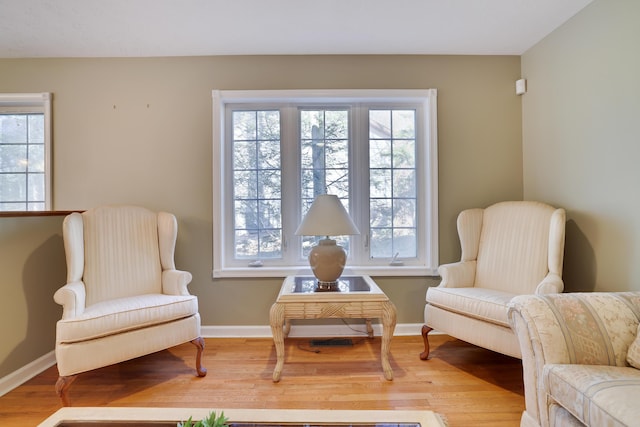 living area with wood finished floors and baseboards