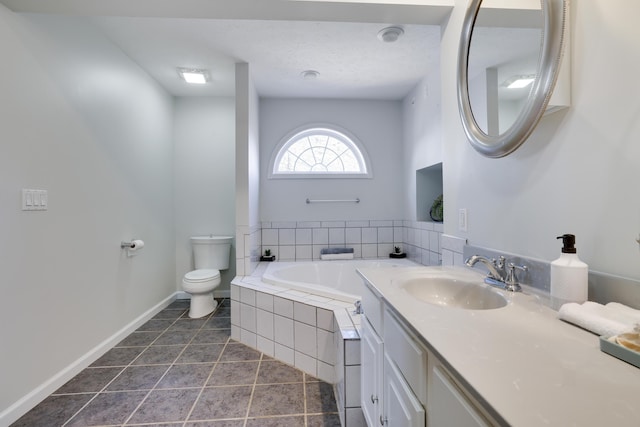 full bath featuring tile patterned floors, a garden tub, toilet, baseboards, and vanity