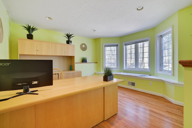 office with recessed lighting, visible vents, light wood-style floors, and a textured ceiling