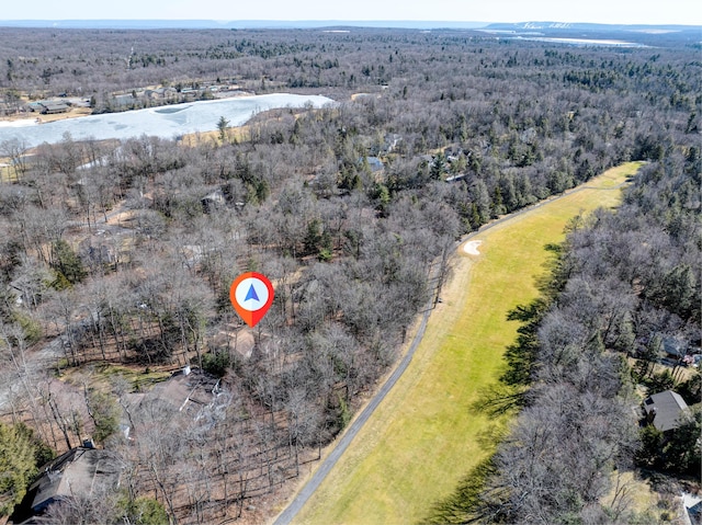 birds eye view of property with a wooded view