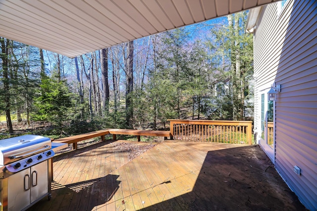wooden deck featuring a grill