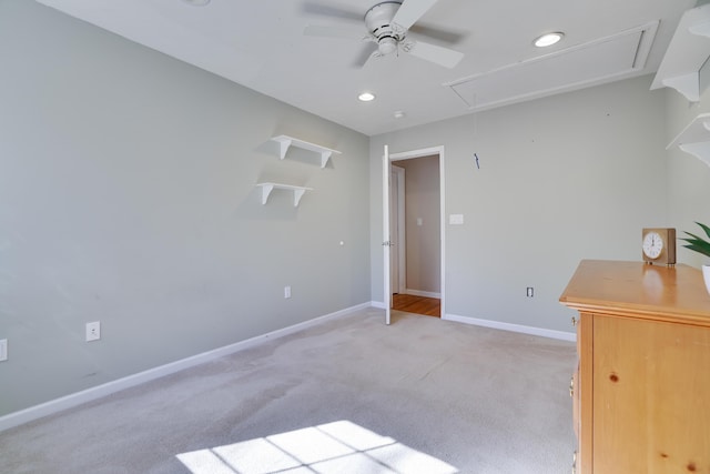 unfurnished room featuring light carpet, a ceiling fan, recessed lighting, baseboards, and attic access
