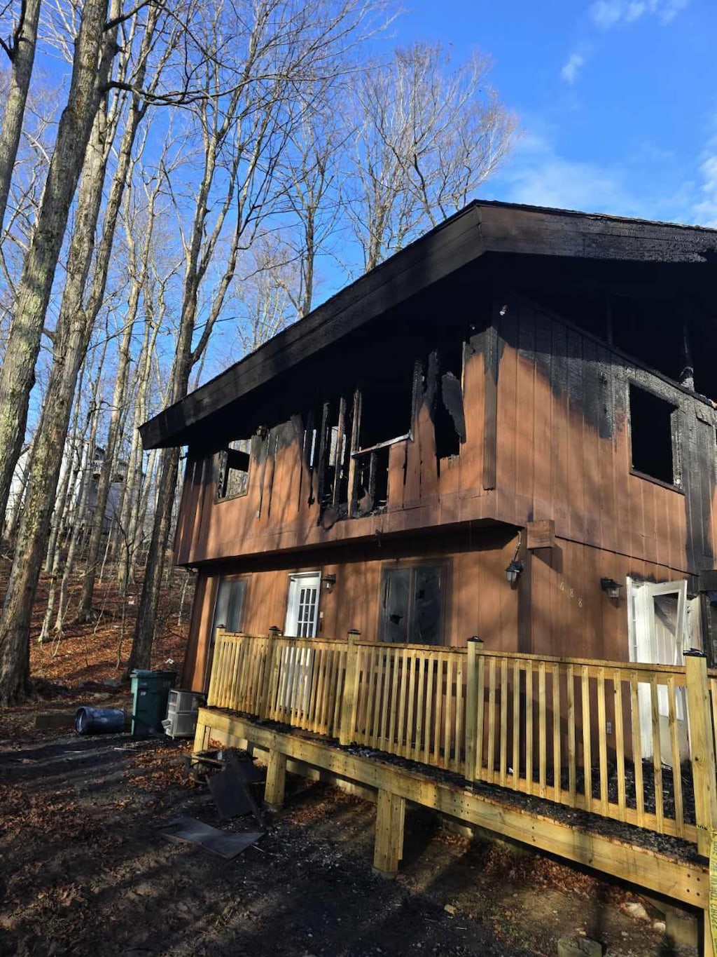 view of side of property with a balcony and central AC unit