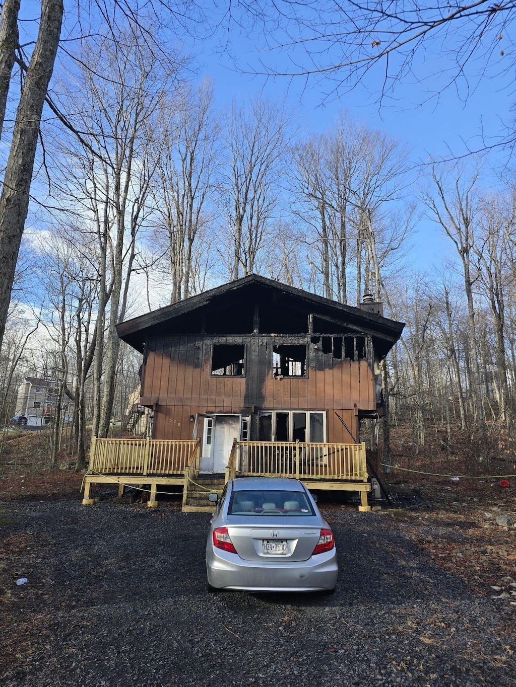 chalet / cabin with a deck and a chimney