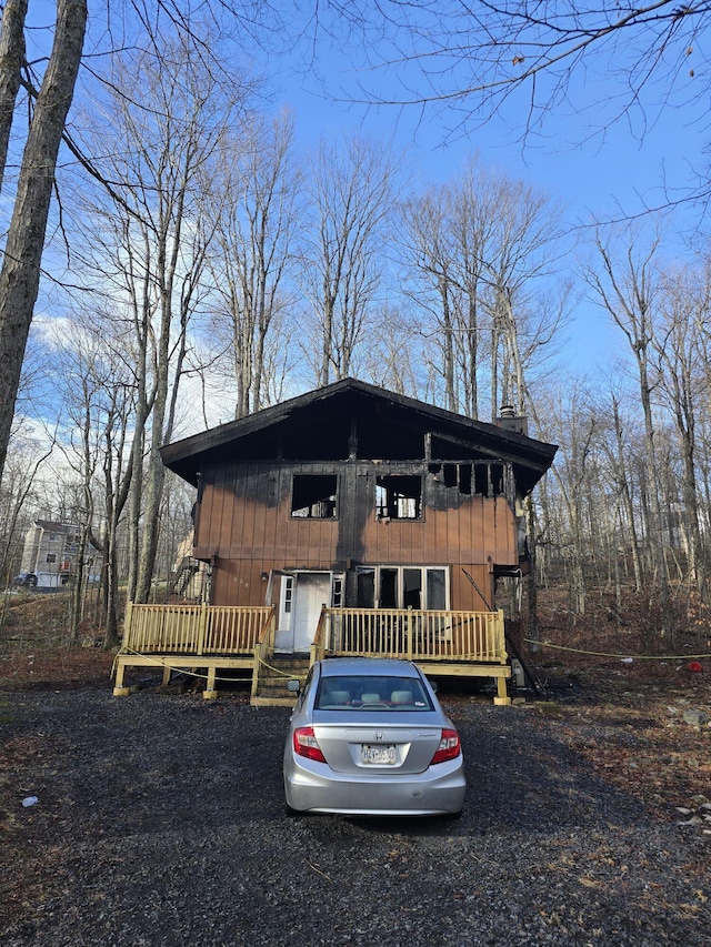 chalet / cabin with a deck and a chimney