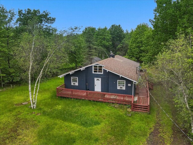 725 Clearview Dr, Long Pond, PA 18334 - view of front of house with a view of trees, a wooden deck, a front lawn, and roof with shingles
