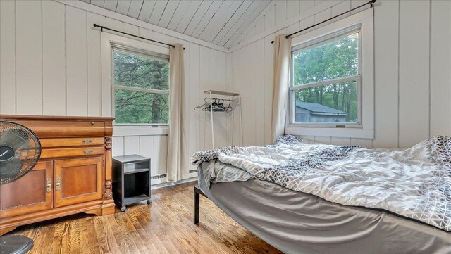 725 Clearview Dr, Long Pond, PA 18334 - bedroom featuring multiple windows, light wood finished floors, vaulted ceiling, and a decorative wall