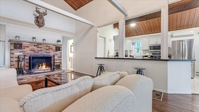 725 Clearview Dr, Long Pond, PA 18334 - living area with wood ceiling, wood finished floors, a fireplace, lofted ceiling, and baseboards