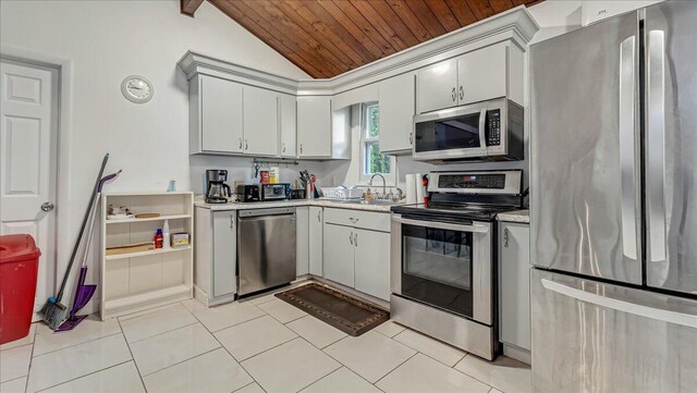 725 Clearview Dr, Long Pond, PA 18334 - kitchen featuring appliances with stainless steel finishes, light countertops, wooden ceiling, light tile patterned floors, and vaulted ceiling