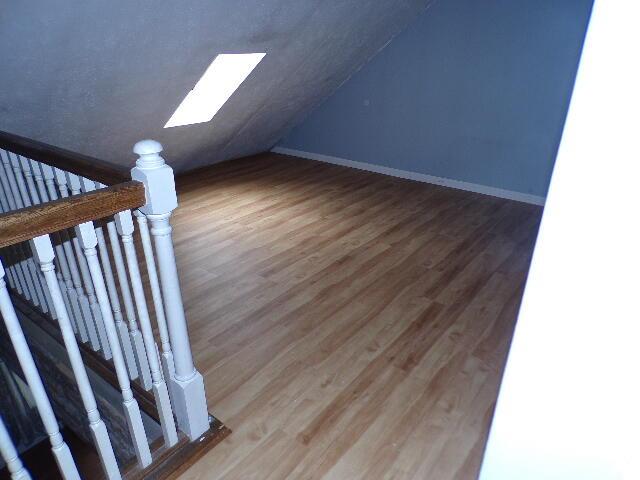 1292 Brentwood Dr, East Stroudsburg, PA 18301 - bonus room featuring wood finished floors, vaulted ceiling, a skylight, and baseboards