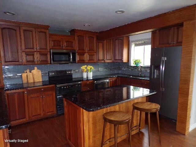 1292 Brentwood Dr, East Stroudsburg, PA 18301 - kitchen with stainless steel microwave, refrigerator with ice dispenser, black / electric stove, a sink, and dark wood-style flooring