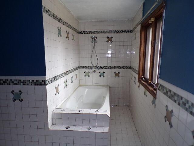 1292 Brentwood Dr, East Stroudsburg, PA 18301 - full bathroom with tile walls, tiled tub, tiled shower, and tile patterned floors