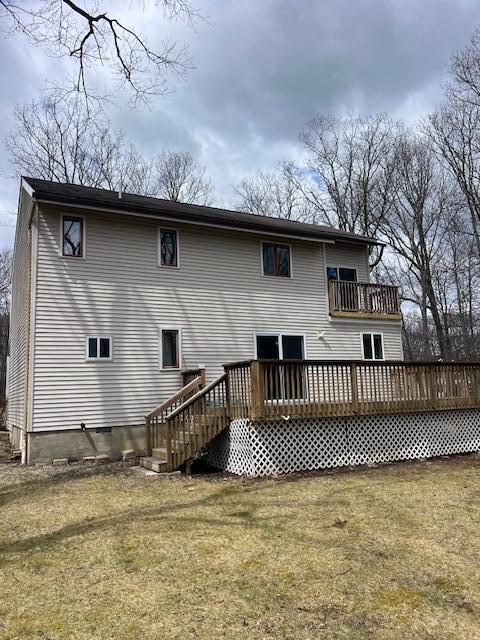 1292 Brentwood Dr, East Stroudsburg, PA 18301 - back of property featuring a balcony, a lawn, and a wooden deck