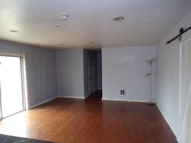 1292 Brentwood Dr, East Stroudsburg, PA 18301 - spare room featuring a barn door, healthy amount of natural light, wood finished floors, and baseboards