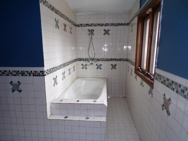 1292 Brentwood Dr, East Stroudsburg, PA 18301 - full bathroom with tile walls, tiled tub, tile patterned floors, and tiled shower
