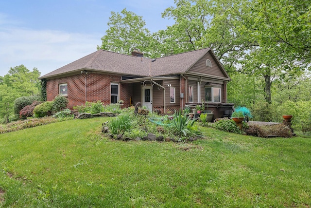 5245 Glenbrook Rd, Stroudsburg, PA 18360 - rear view of house featuring brick siding, a chimney, a lawn, and a shingled roof