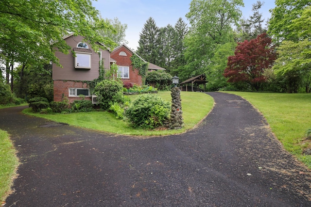 5245 Glenbrook Rd, Stroudsburg, PA 18360 - view of front facade featuring brick siding and a front lawn