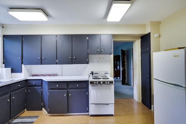 5245 Glenbrook Rd, Stroudsburg, PA 18360 - kitchen featuring white appliances, decorative backsplash, light countertops, ornamental molding, and light wood-style flooring