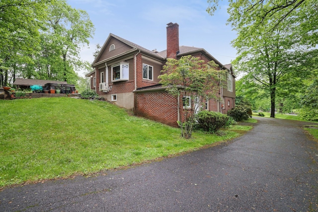 5245 Glenbrook Rd, Stroudsburg, PA 18360 - view of property exterior with a chimney, a yard, and brick siding