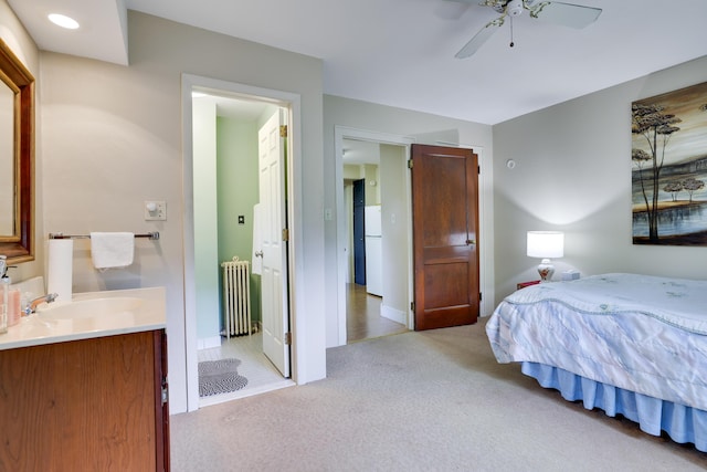 5245 Glenbrook Rd, Stroudsburg, PA 18360 - bedroom with radiator, a sink, light carpet, baseboards, and ceiling fan