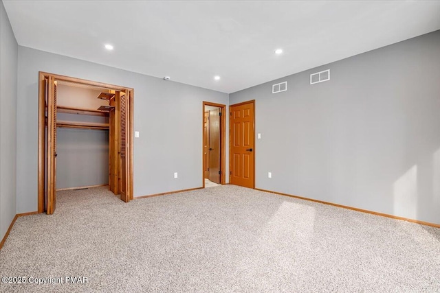 unfurnished bedroom with a closet, carpet, and a walk in closet