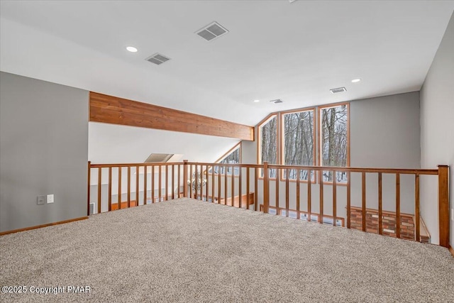 carpeted spare room with lofted ceiling with beams