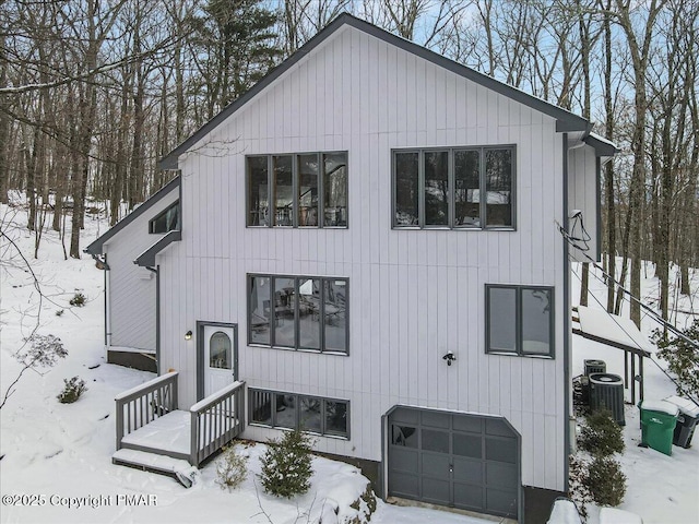 view of front of house with a garage and central AC unit