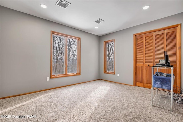 unfurnished bedroom featuring carpet and a closet