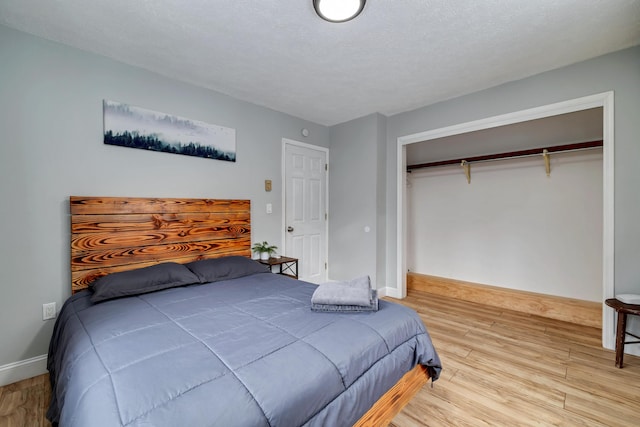 982 Long Ridge Rd, Hawley, PA 18428 - bedroom featuring baseboards, a closet, wood finished floors, and a textured ceiling