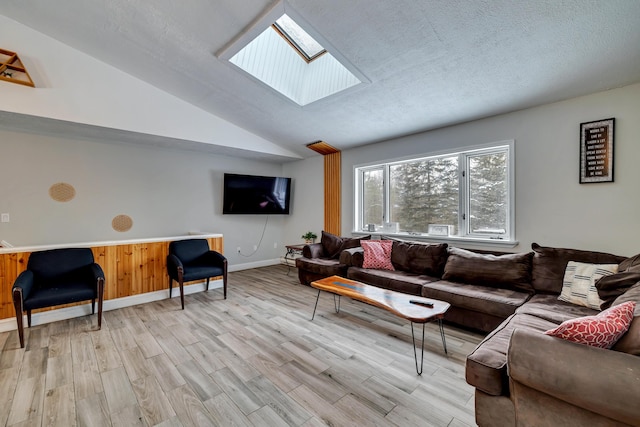 982 Long Ridge Rd, Hawley, PA 18428 - living area with a textured ceiling, vaulted ceiling with skylight, and light wood-type flooring