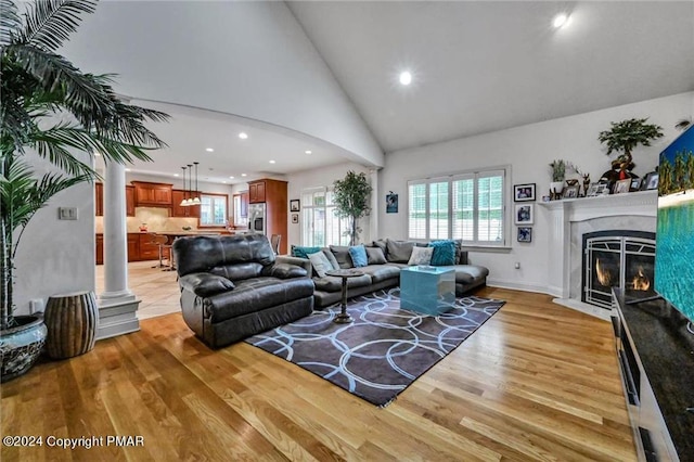 187 Eisenhart Blvd, Bangor, PA 18013 - living area featuring recessed lighting, light wood-type flooring, a fireplace with flush hearth, arched walkways, and high vaulted ceiling