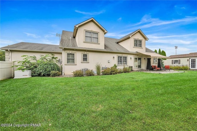 187 Eisenhart Blvd, Bangor, PA 18013 - back of property featuring stucco siding, a patio, a lawn, central air condition unit, and a shingled roof