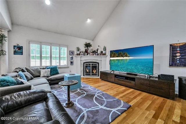 187 Eisenhart Blvd, Bangor, PA 18013 - living area featuring wood finished floors, a glass covered fireplace, high vaulted ceiling, and recessed lighting
