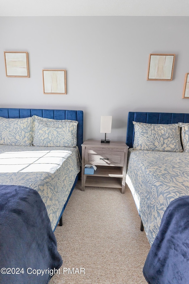 bedroom featuring carpet and baseboards