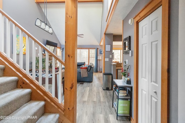 foyer with light wood-style floors and stairway