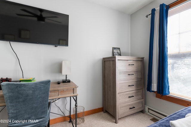 bedroom with baseboards, baseboard heating, and light colored carpet