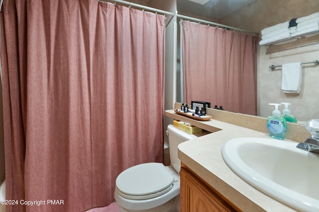 full bath featuring toilet, a shower with shower curtain, and vanity