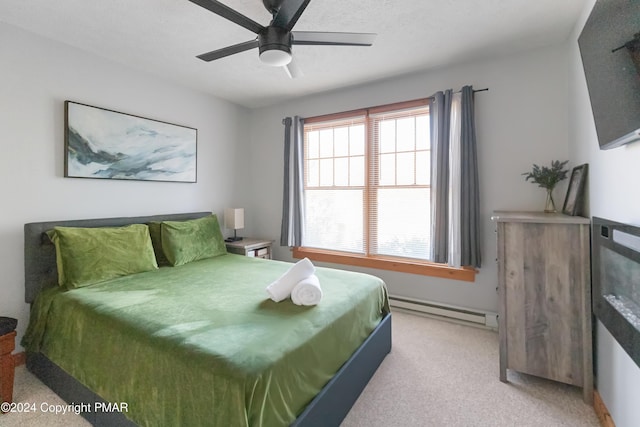 bedroom featuring ceiling fan, baseboard heating, and light colored carpet