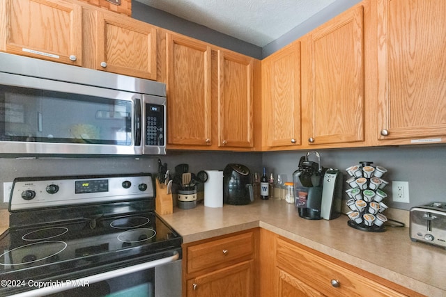 kitchen featuring stainless steel appliances and light countertops