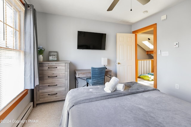 bedroom with a ceiling fan, a baseboard radiator, and light colored carpet