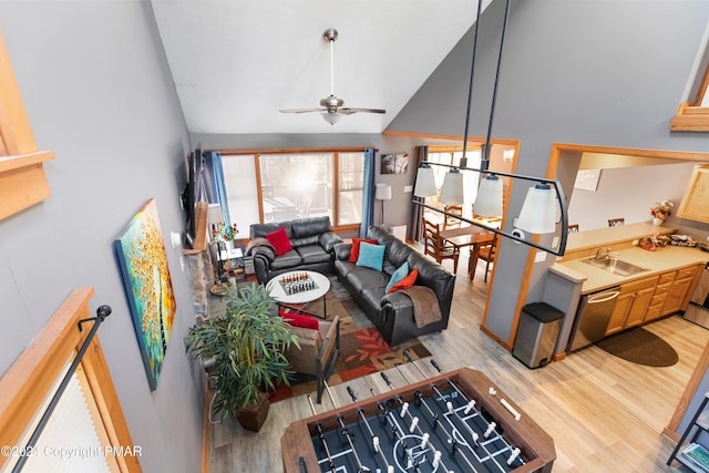 living room featuring high vaulted ceiling, light wood finished floors, and a ceiling fan