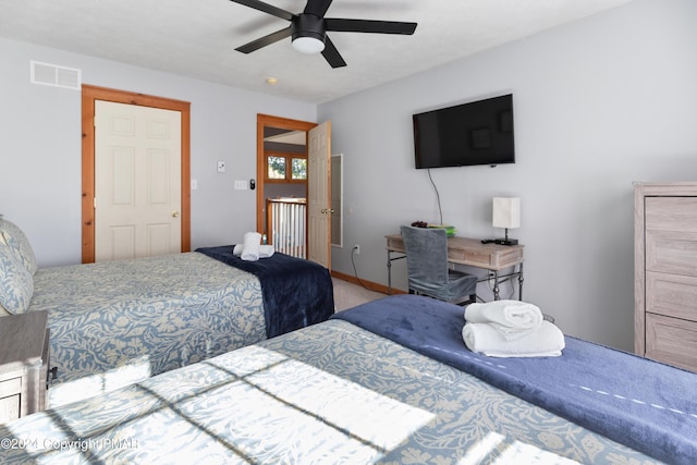 carpeted bedroom featuring visible vents, ceiling fan, and baseboards