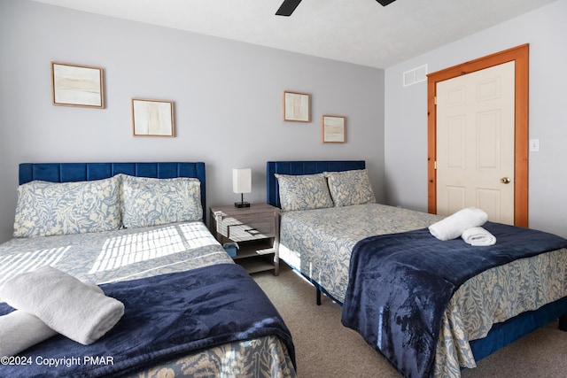 bedroom featuring carpet floors, visible vents, and a ceiling fan