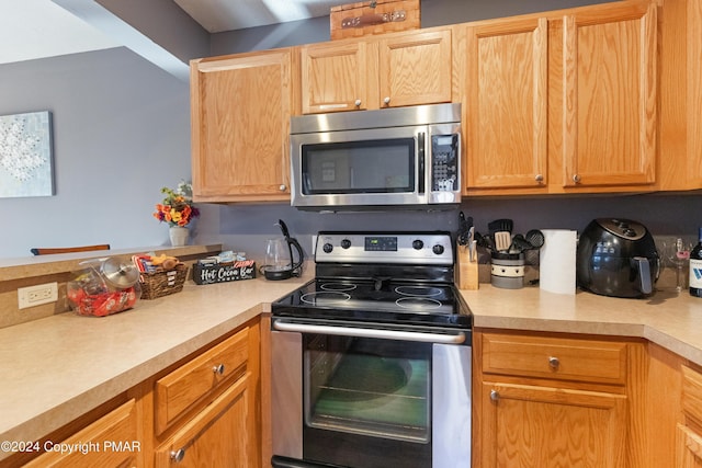 kitchen featuring appliances with stainless steel finishes and light countertops