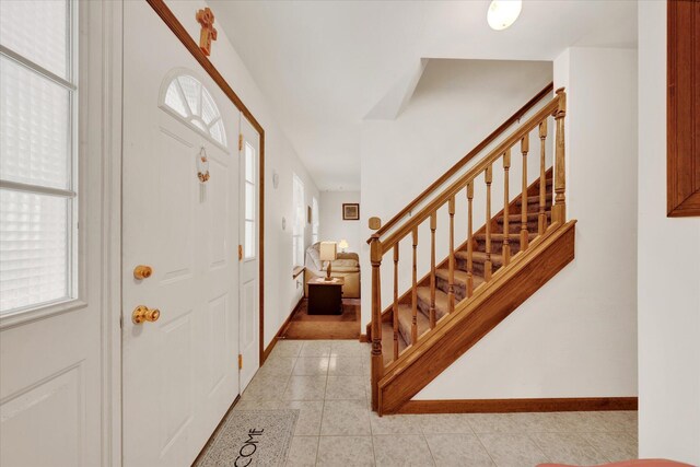 146 Bernadette Dr, Dingmans Ferry, PA 18328 - entryway with stairs, light tile patterned floors, and baseboards