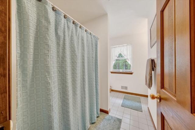146 Bernadette Dr, Dingmans Ferry, PA 18328 - bathroom with tile patterned flooring, toilet, a shower with shower curtain, and baseboards