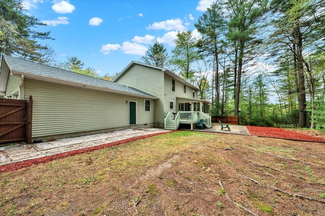 146 Bernadette Dr, Dingmans Ferry, PA 18328 - back of house featuring a patio, a sunroom, a gate, roof with shingles, and fence